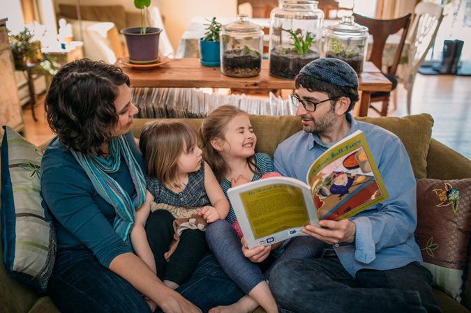 Family reading a PJ Library Passover book