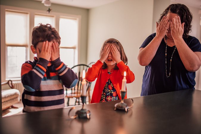 A family gets ready to begin Shabbat.